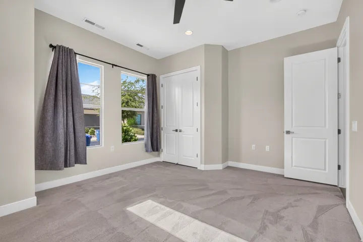 Recessed lighting, ceiling fan, neutral wall paint, white trim, and light gray carpet