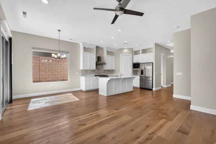 Open-concept interior featuring wood-finish flooring, recessed lighting, and a ceiling fan