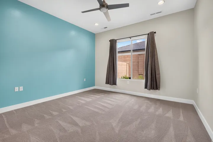 Recessed lighting, ceiling fan, large window, and wall-to-wall carpeting