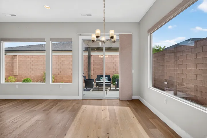 Wood-finish flooring, recessed lighting, and multiple large windows
