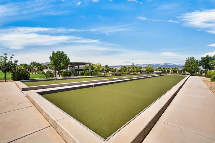 Dual bocce ball courts featuring artificial turf surfaces and concrete borders