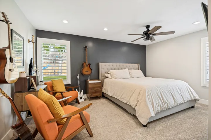 Plush carpeting, recessed lighting, and a ceiling fan with light fixture