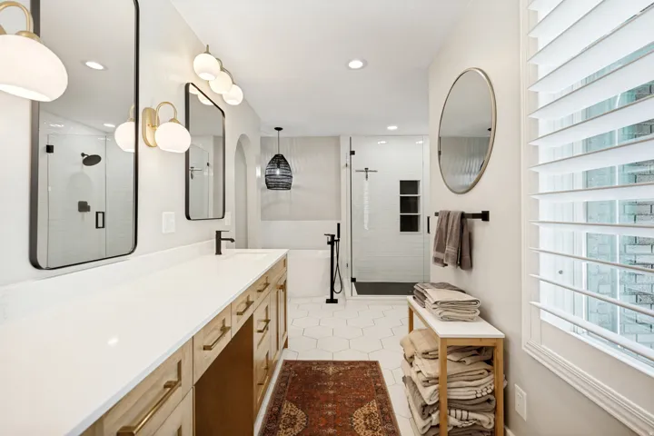 Dual vanity with a white countertop and wood-finish cabinetry