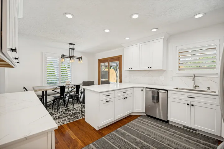 Kitchen featuring white shaker-style cabinetry, stainless steel appliances, a white countertop, and recessed lighting