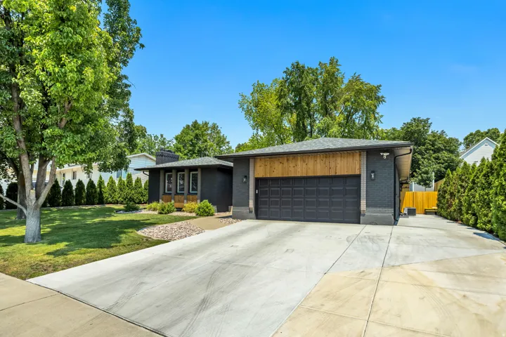 Contemporary exterior with black brick and natural wood-tone siding accents