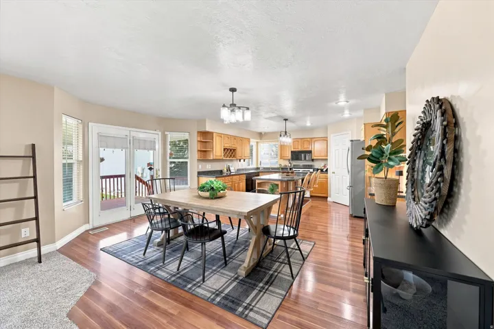 Hardwood flooring, bay window, sliding glass doors to a deck, and recessed lighting