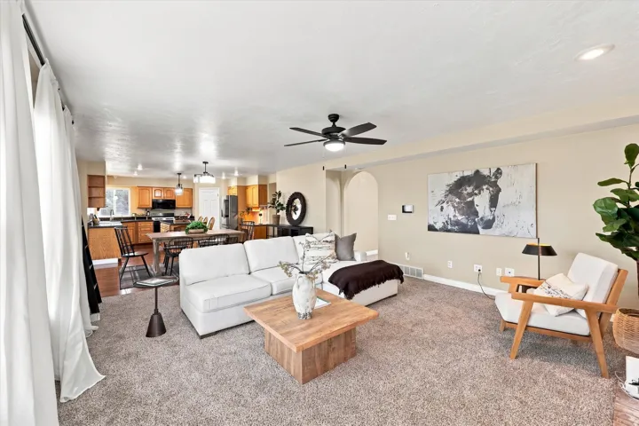 Spacious living area featuring carpeted flooring and recessed lighting