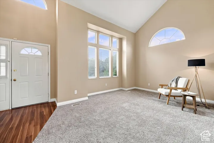 Vaulted ceiling and high transom windows create a spacious entry