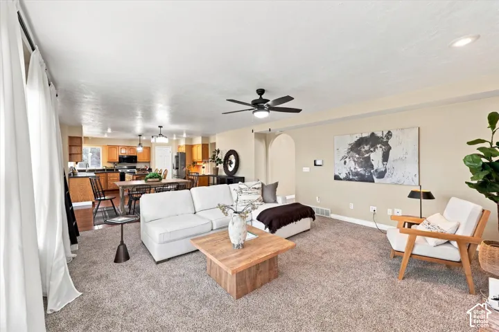 Spacious living area featuring carpeted flooring and recessed lighting