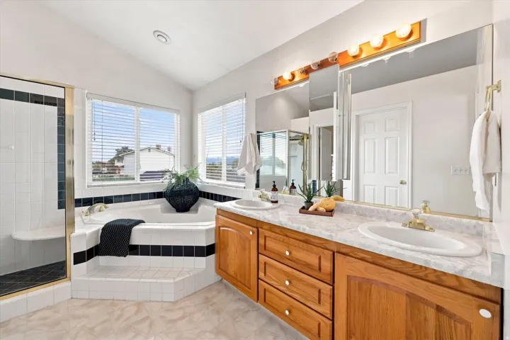 Dual vanity with wood-finish cabinetry and integrated sinks