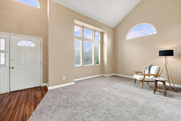Vaulted ceiling and high transom windows create a spacious entry