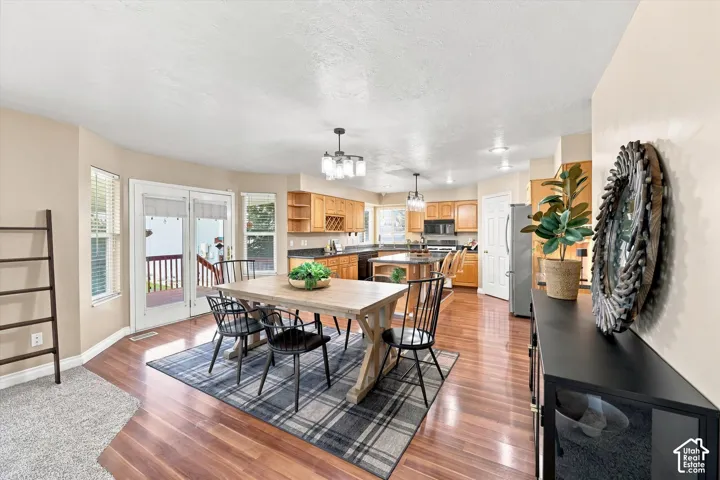 Hardwood flooring, bay window, sliding glass doors to a deck, and recessed lighting