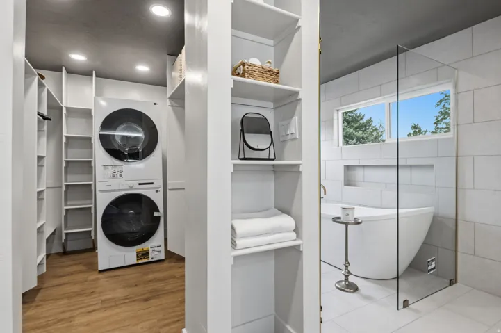 Primary walk in closet with full stackable laundry
