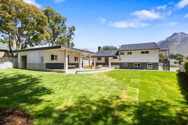 massive backyard with views of mt olympus, fully automated sprinklers and mature tree. fire pit covered patios