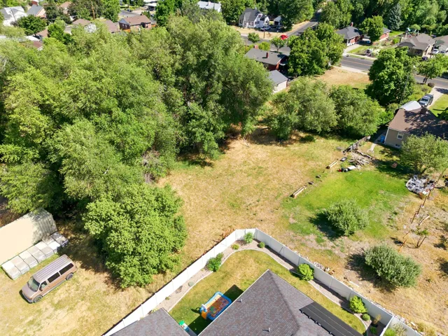 Expansive property lot featuring mature trees and established fencing