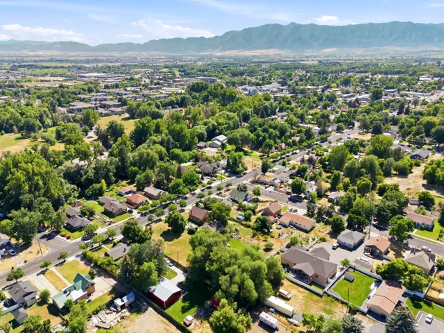 Expansive residential area with abundant mature trees and mountainous terrain