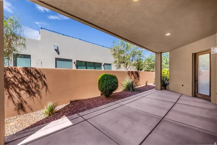 Covered patio with concrete flooring, recessed lighting, and a glass-paneled exterior door