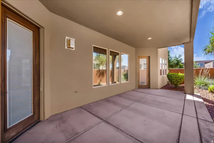 Covered concrete patio with recessed lighting and multiple access points