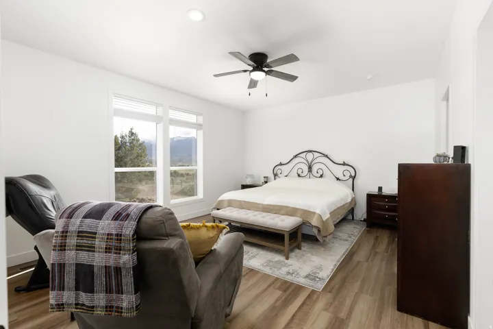 Recessed lighting, ceiling fan with light, wood-finish flooring, and multiple windows