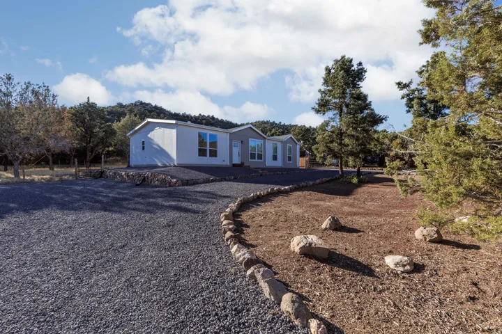 Contemporary exterior with light gray siding and white trim windows