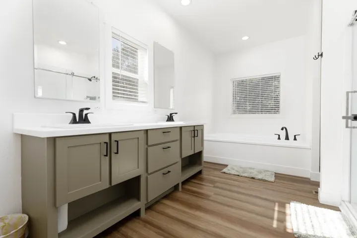 Dual vanity with neutral cabinetry and matte black fixtures