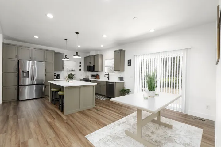 Contemporary kitchen featuring extensive gray cabinetry and a kitchen island with a white countertop