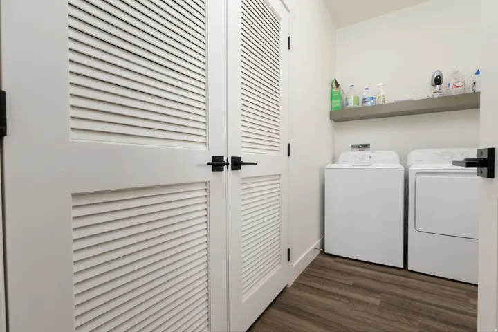 White louvered doors with matte black hardware