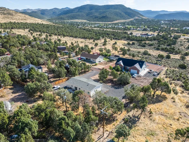 Expansive mountain landscape with diverse terrain, featuring scattered residential properties