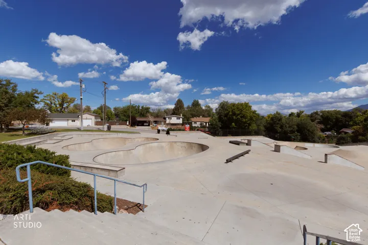 Walking distance to expansive skatepark featuring concrete bowls, ramps, and grinding rails