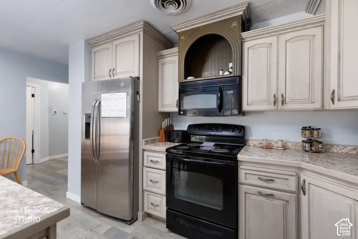 Kitchen featuring wood-finish cabinetry, light-toned countertops, and a full suite of appliances