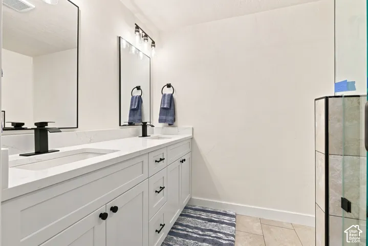 Master Bath, dual sink vanity with white cabinetry, matte black hardware, stone-look countertops, and rectangular mirrors