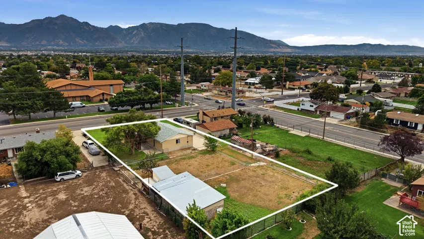 Single-story residence with an attached garage, featuring a paved driveway and a spacious yard