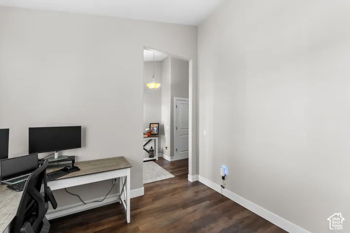 Wood-finish flooring, light gray wall tones, and white trim