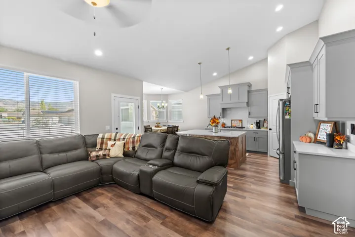 Spacious living area with wood-finish flooring and vaulted ceilings