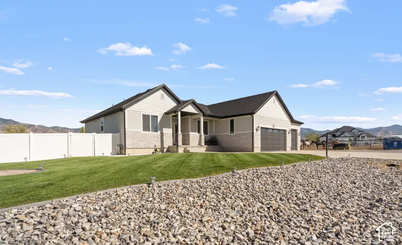 Contemporary ranch-style residence featuring a combination of horizontal siding and stone veneer