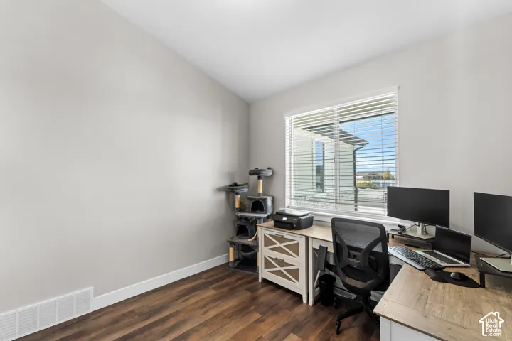 Wood-finish flooring, white walls, and a large window with white blinds