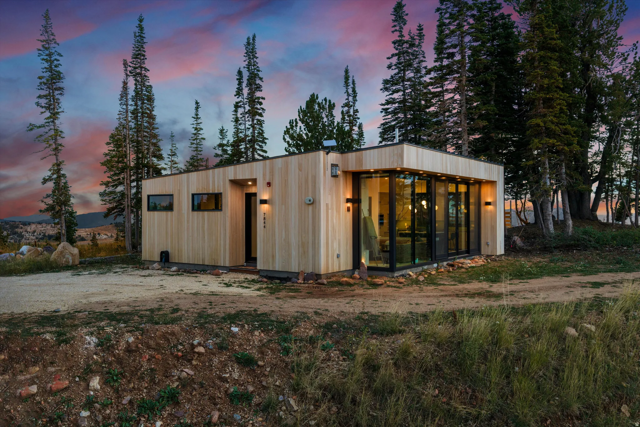Modern exterior featuring natural wood siding and large floor-to-ceiling windows