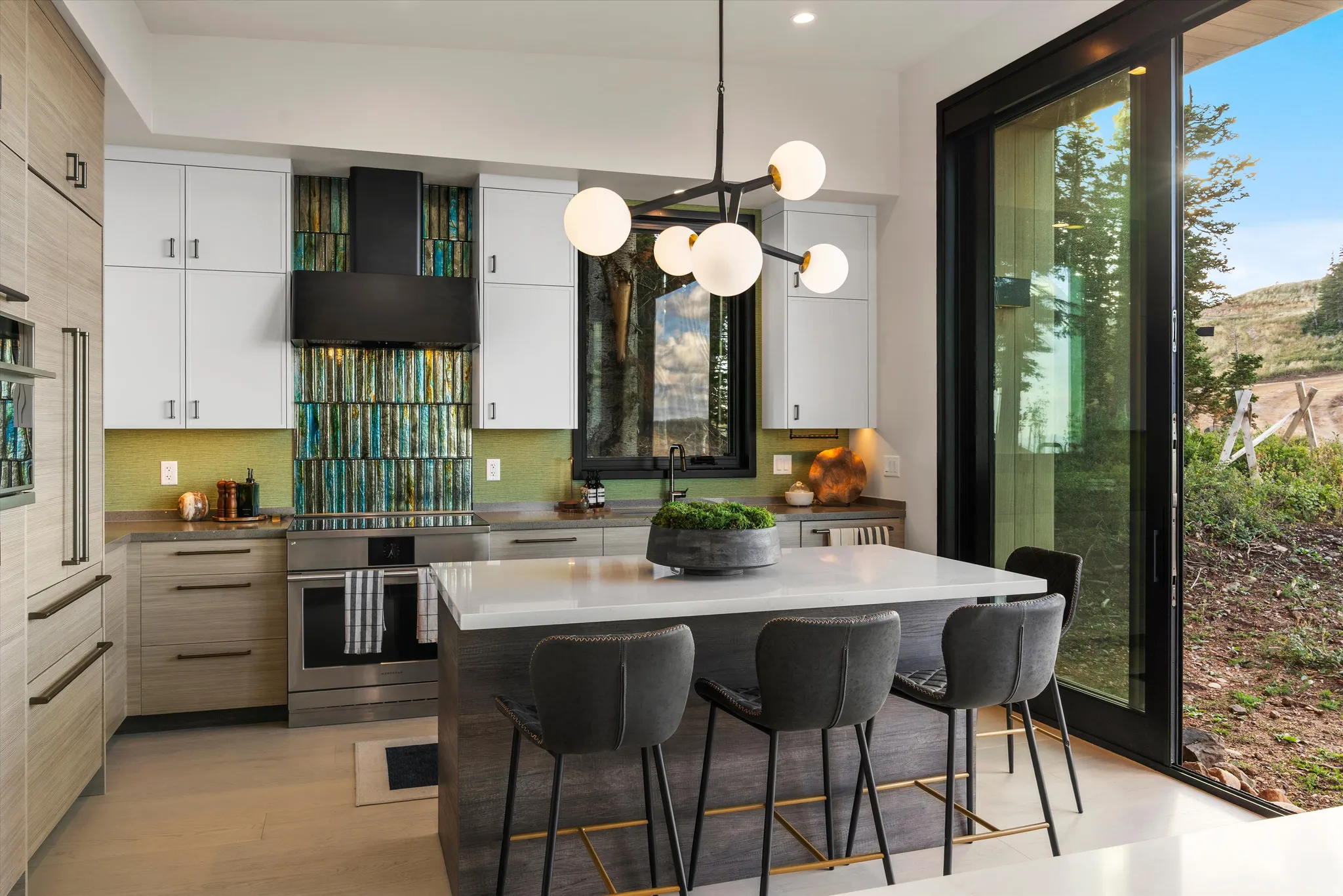 Gourmet kitchen with stainless steel appliances, custom cabinetry, a large kitchen island with seating, and a striking backsplash