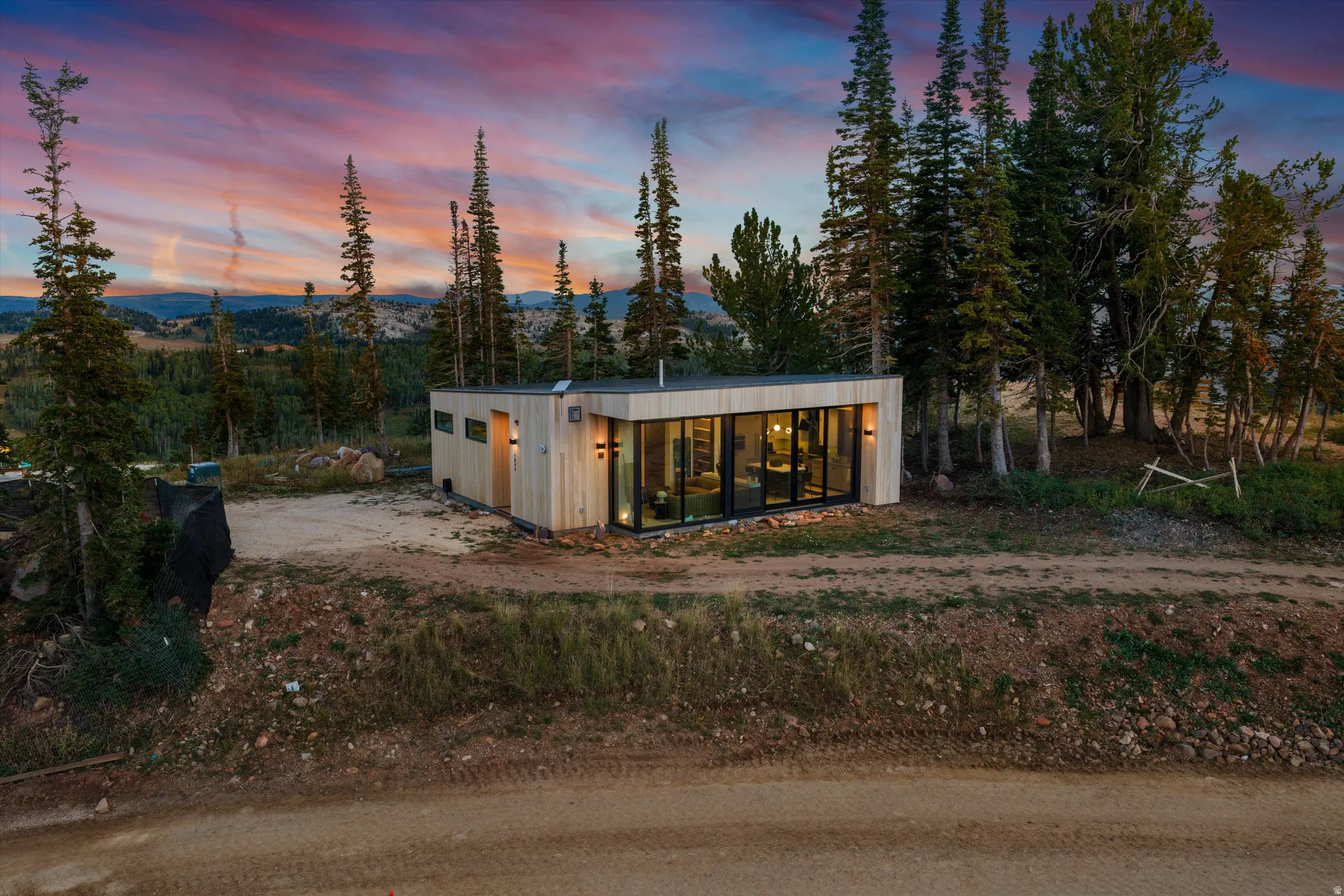 Modern rectangular exterior featuring natural wood-paneled siding and a flat roof