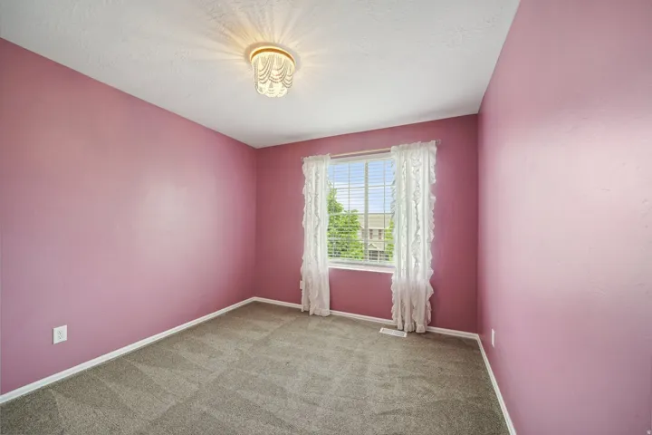 Window with horizontal blinds, carpeted flooring, and a ceiling-mounted light fixture