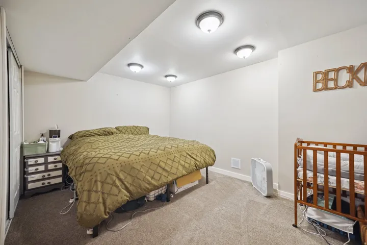 Recessed ceiling lights, neutral wall paint, and gray carpet flooring