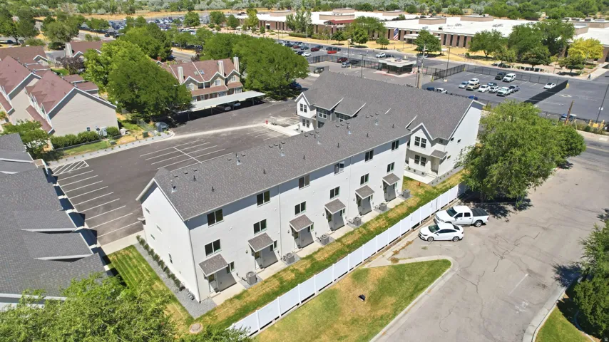 Modern multi-unit property with a gabled roofline and light-toned exterior siding