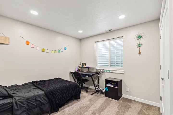 Recessed lighting, window with blinds, light-colored walls, carpeted flooring, and white trim