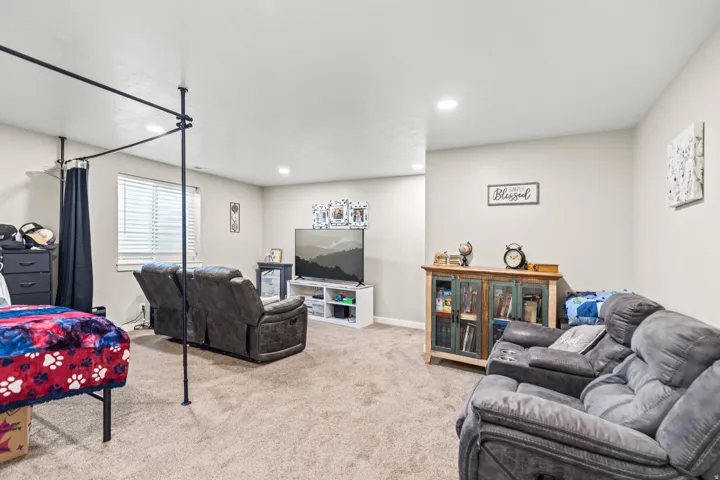 Recessed lighting, light-toned walls, and carpet flooring