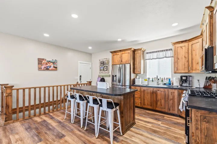Kitchen featuring wood-finish flooring, recessed lighting, and wood cabinetry