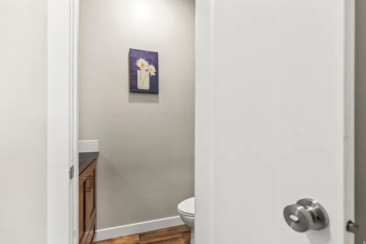 Wood-finish flooring with a white baseboard