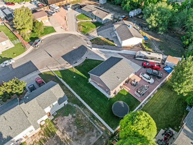 Manicured lawn, paved patio area, white picket fencing, asphalt shingle roofing, and a cul-de-sac location