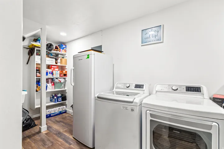 Utility space featuring wood-finish flooring, recessed lighting, and built-in shelving