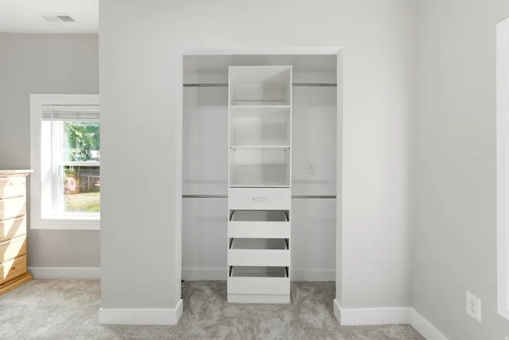 Custom closet system with shelving and drawers