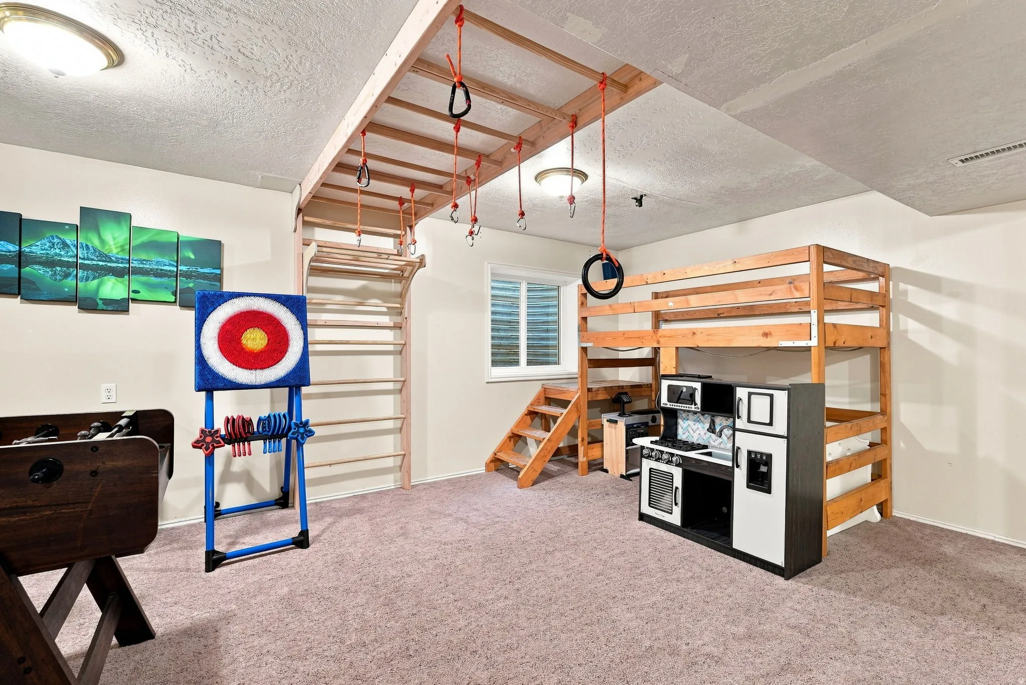 Recreation room featuring a built-in climbing structure, a window, and recessed lighting